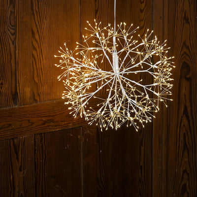 Decorative light fixture with LED bulbs on a wooden background