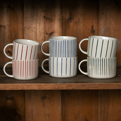 Six striped mugs on a shelf