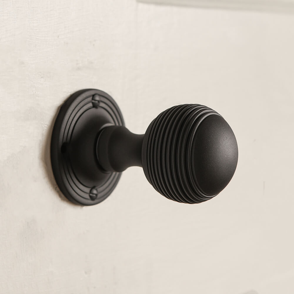 matt black beehive door handle on a door