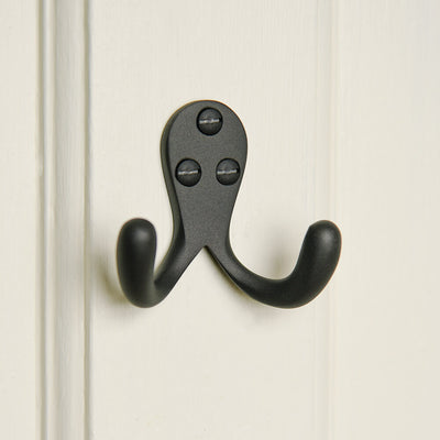 black double hook for robes on a cream door