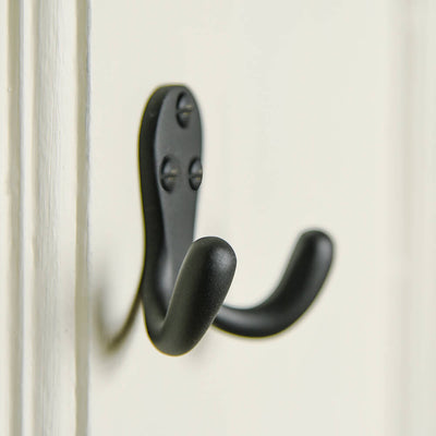 black matt hooks on a door with matching screws