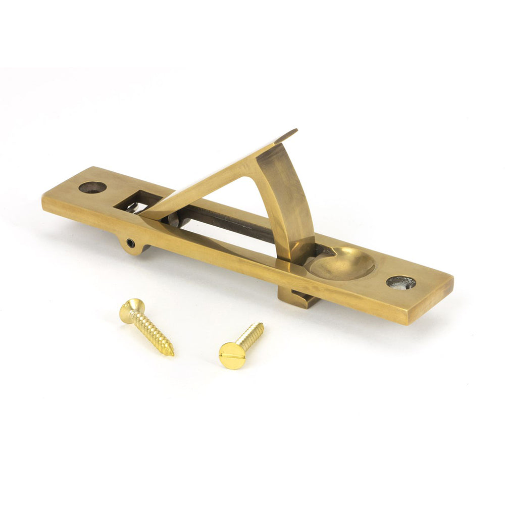 Aged brass sliding door edge pull with the handle open and brass screws