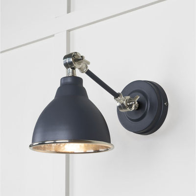 Hammered nickel Brindley wall light in slate against a white panelled wall