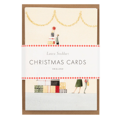Pack of Christmas cards with illustrations of gift-wrapping and people, featuring the brand 'Laura Stoddart'.