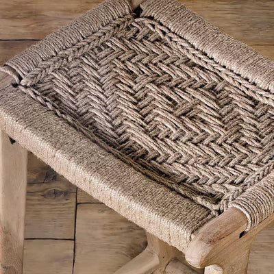 Close up of the woven jute seat on the mango wood stool with geometric patterns