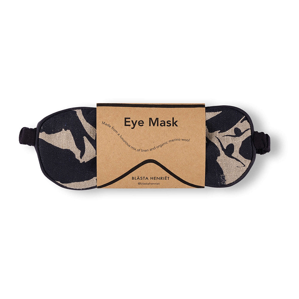 Navy and white patterned eye mask that is made from linen and soft wool in packaging against white background