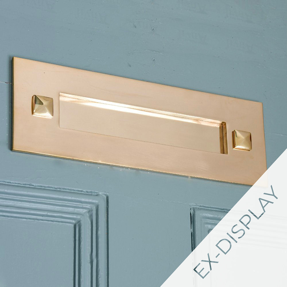 Polished brass traditional letterplate without clapper on a blue door with a watermark and ex display text in the corner