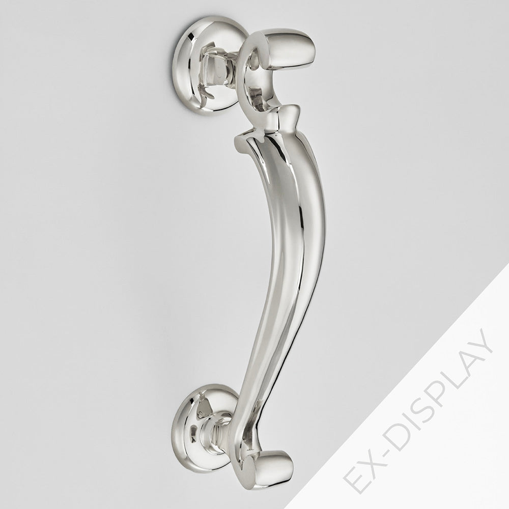 Polished nickel extra large doctors door knocker on a pale grey background with an ex-display watermark in the corner