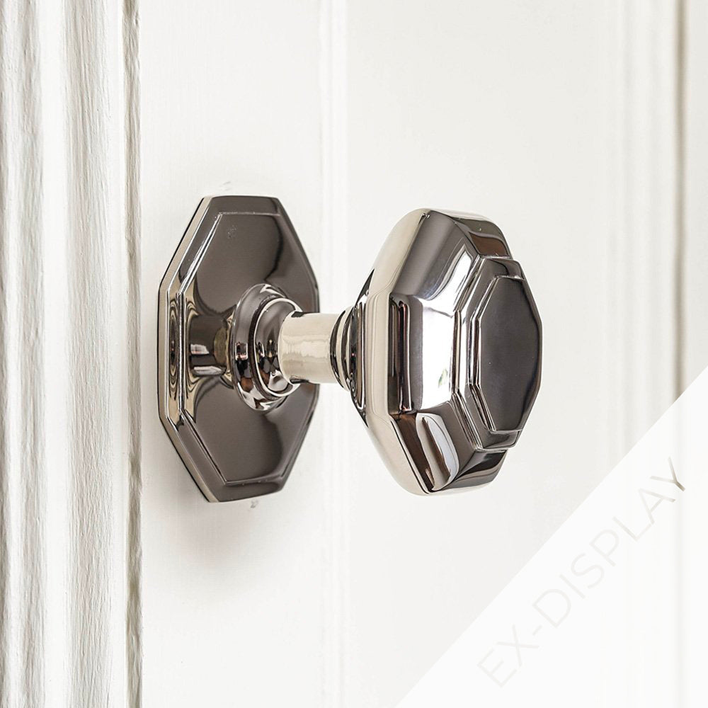 Small polished nickel flat octagonal door pull on an off-white door with a watermark and ex display text in the corner