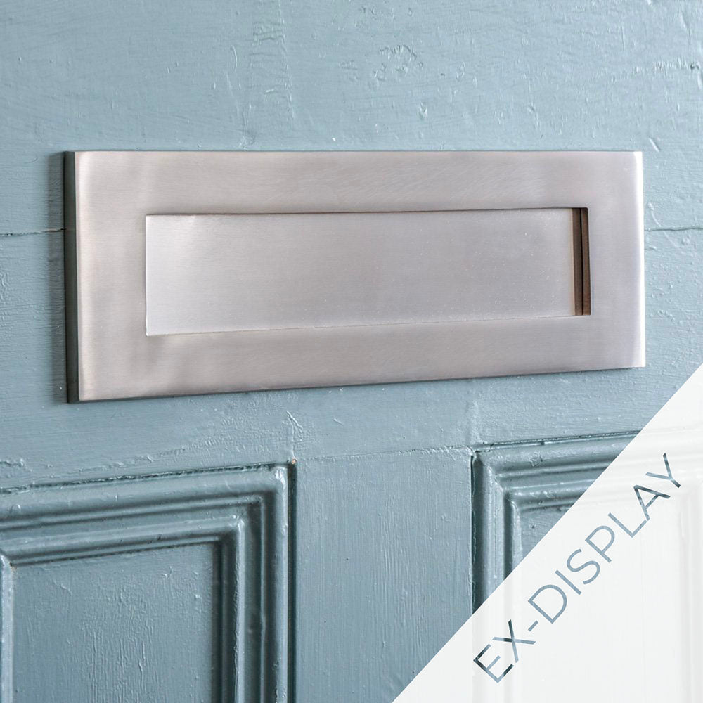 Ex display satin nickel front door letterplate on a pale blue door with an ex-display watermark in the corner