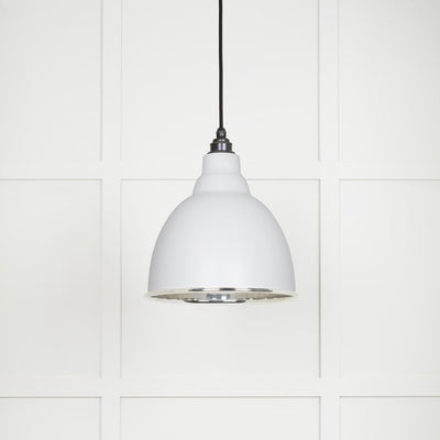 Smooth polished nickel Brindley pendant light with a powder coated finish in flock hanging from a black fabric cable against a white panelled wall