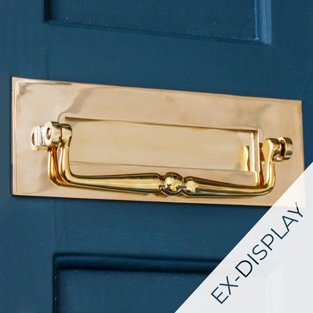 Traditional solid brass letterplate with a clapper on a dark blue door with ex-display watermark in the corner