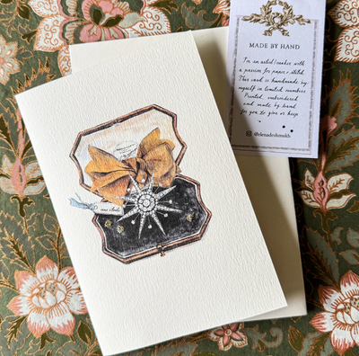 Card with decorative design on a floral-patterned surface