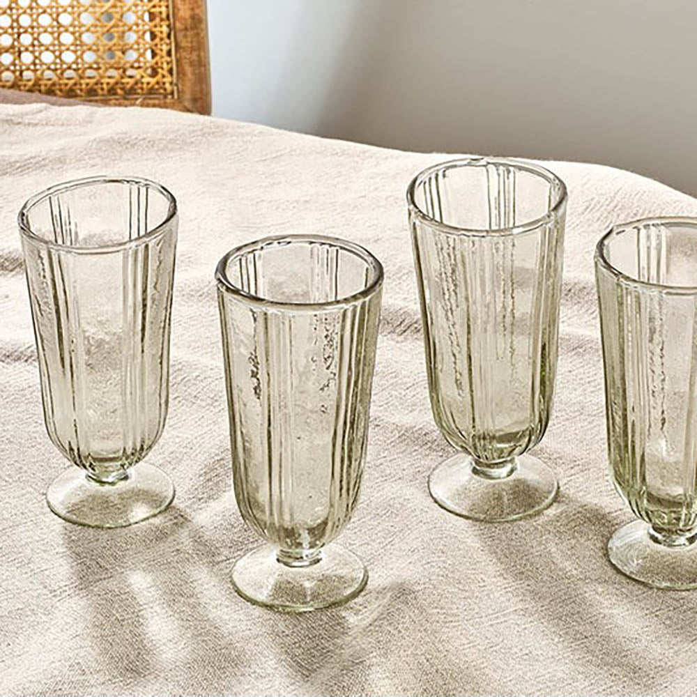 Set of 4 tall recycled glass wine glasses with linear ridged detail on taupe tablecloth