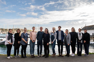 The Willow & Stone team stood in front of Falmouth harbour
