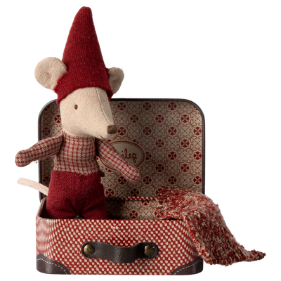 A plush toy depicting a baby mouse in a red and white suit with a Santa hat, sitting on top of a suitcase with a Christmas pattern.