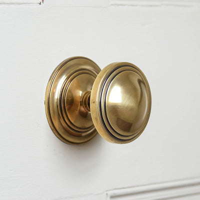 A Round Art Deco Centre Door Pull in an aged brass finish