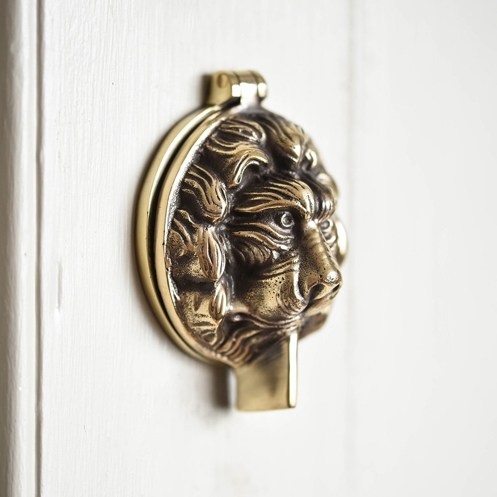 Aged brass lion head latch cover
