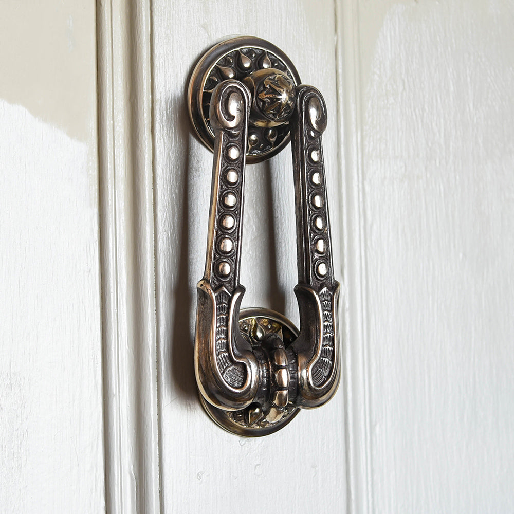 Aged brass regency style door knocker