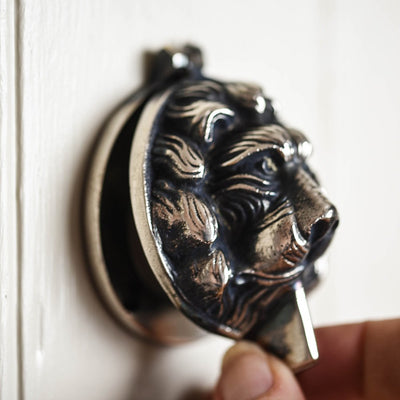 Aged nickel lion head latch cover open