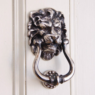 Aged nickel lion's head door knocker