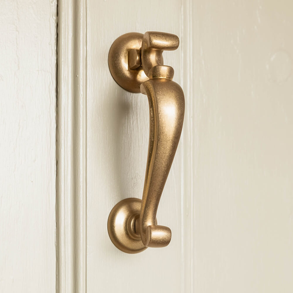 Elegant aged brass door knocker
