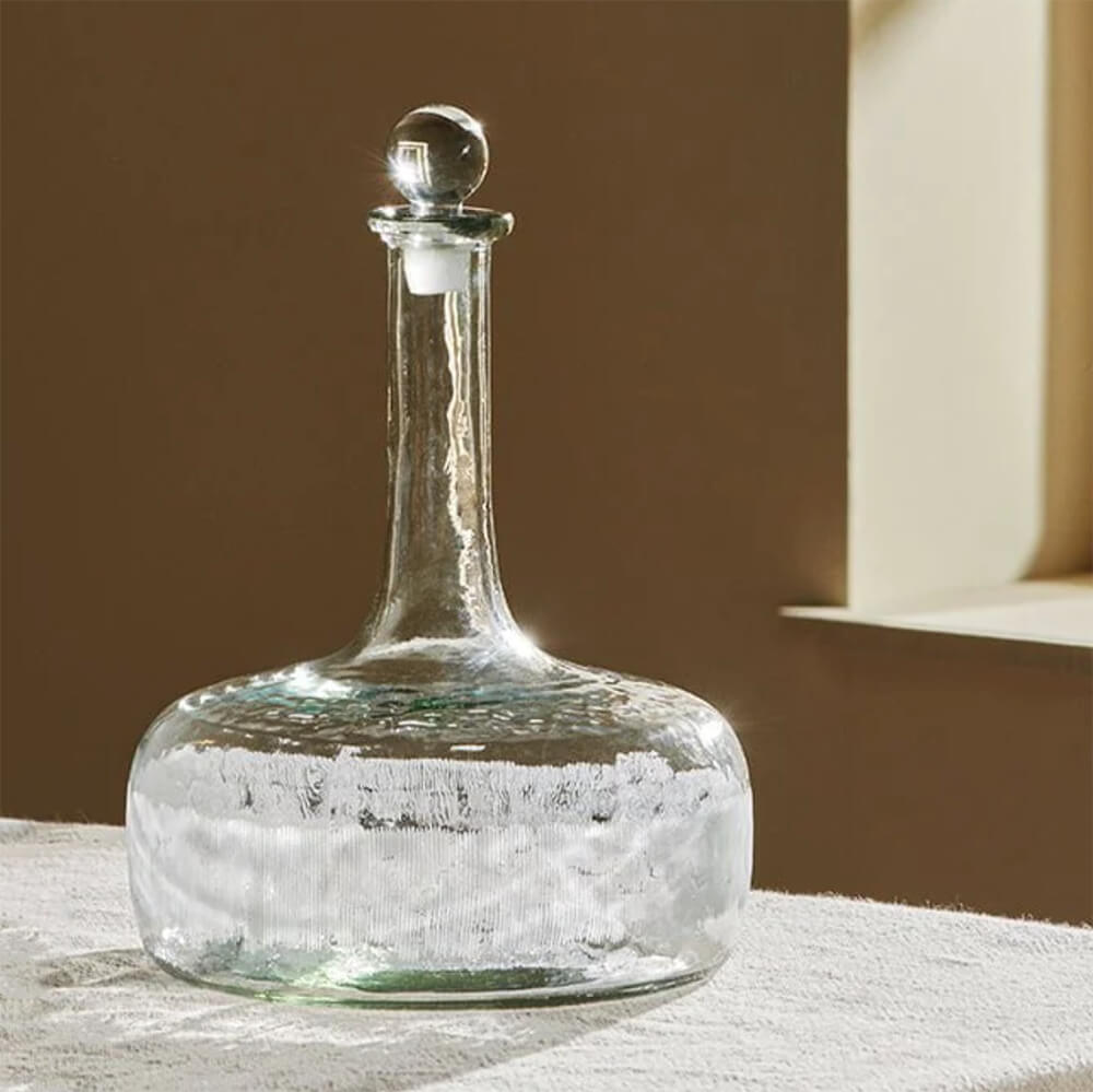 Etched glass decanter on table