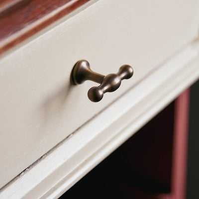 t bar anchor cupboard pull in distressed antique brass on kitchen unit seen from an angle