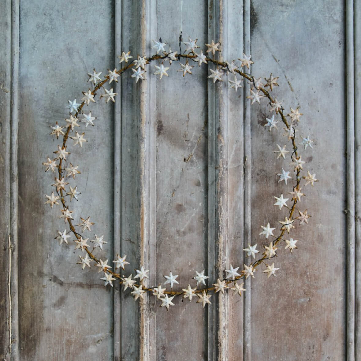 LED fairly light star wreath on rustic panelling