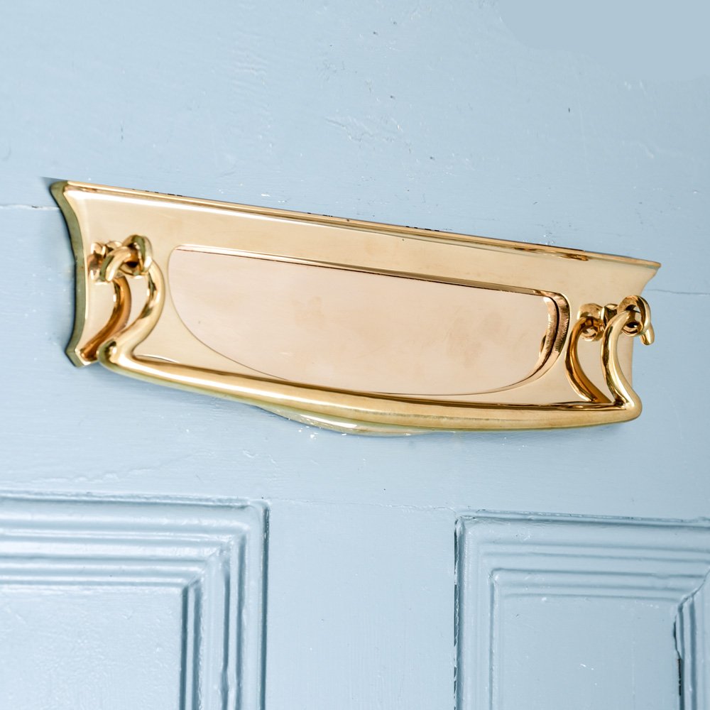 An Art Deco Letterplate in a Brass finish with a clapper