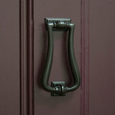 Art Deco Bronze door knocker on purple front door