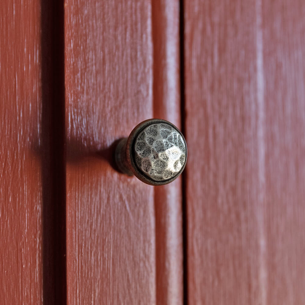 Beaten Pewter Cabinet Knob 20mm on red cabinet