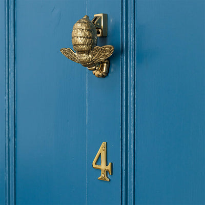 Brass Bumble Bee Door Knocker on blue door with brass number 4