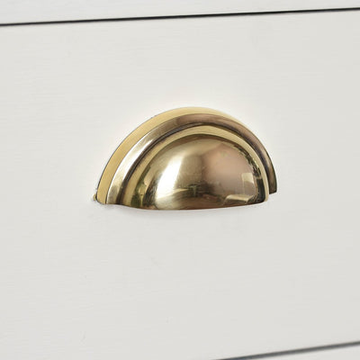 The regency style concealed screw hooded drawer pull in aged brass fitted to a draw