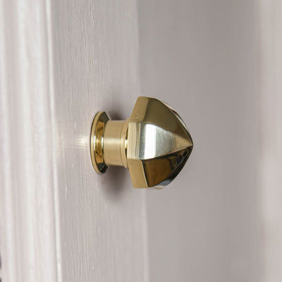 Side profile of brass pointed octagonal cabinet knob