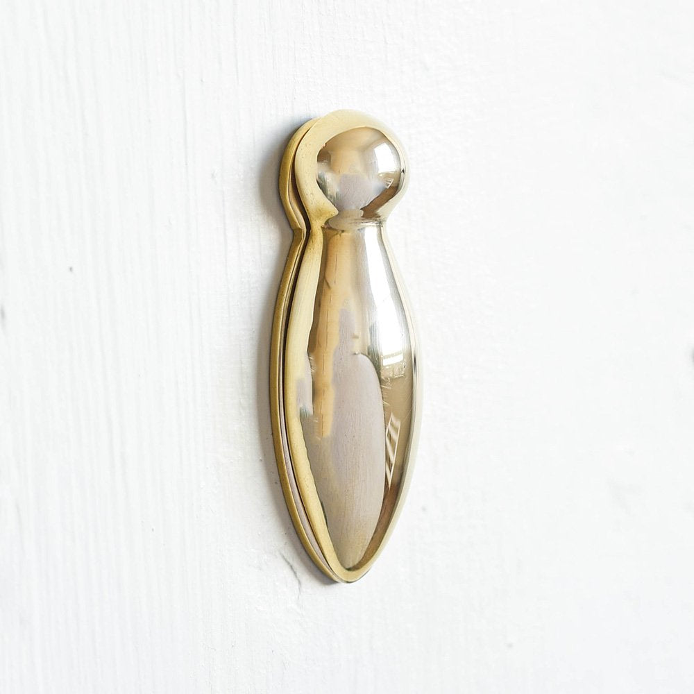 Solid brass keyhole escutcheon with a swing cover. Shaped in a classic pear drop design