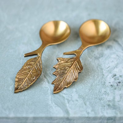 Two brass spoons with leaf shaped handles