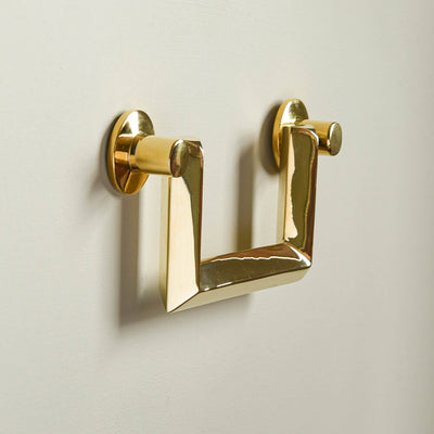 Regal brass drop handle for drawers seen in profile