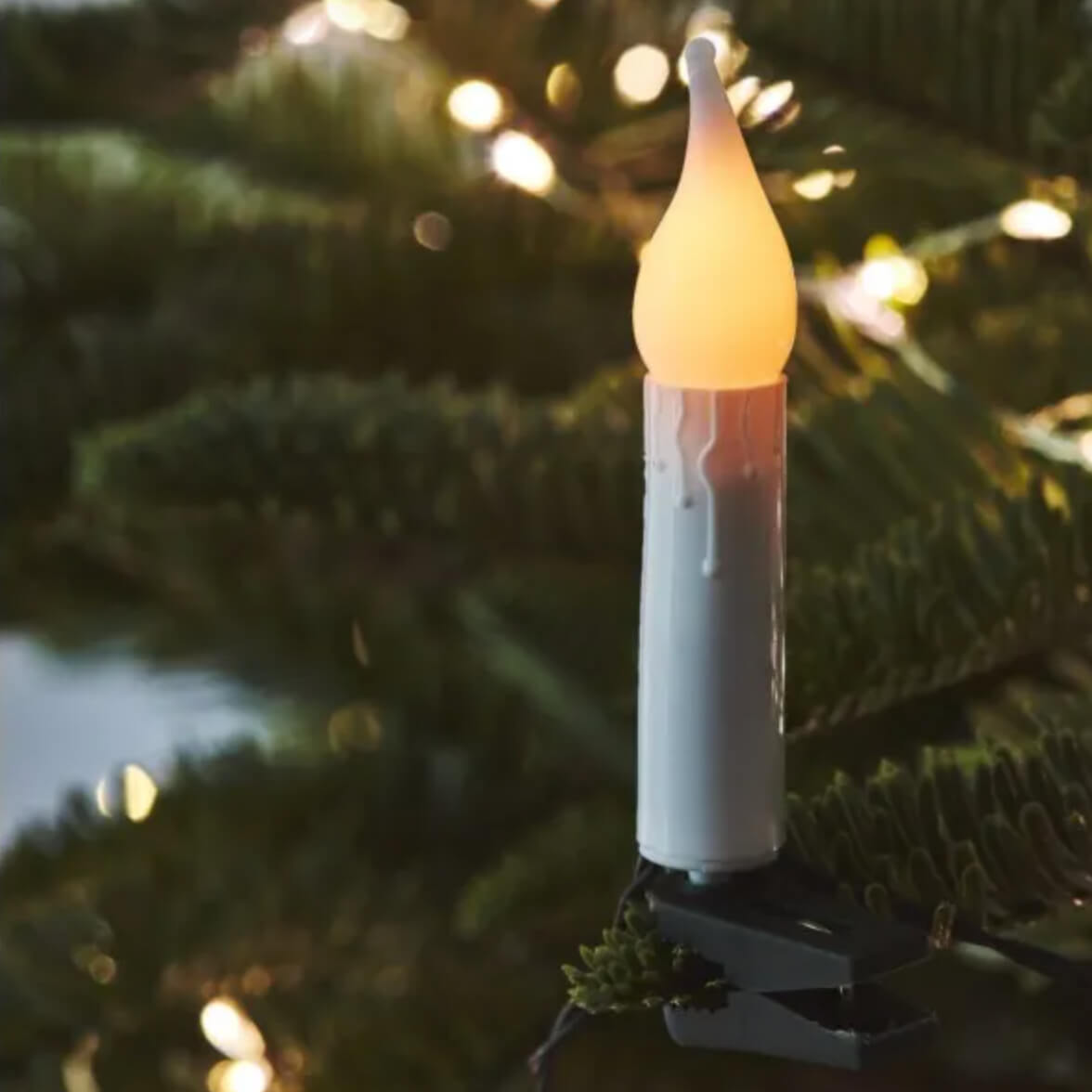 An individual Clip on candle fairy light Christmas lights seen on a tree