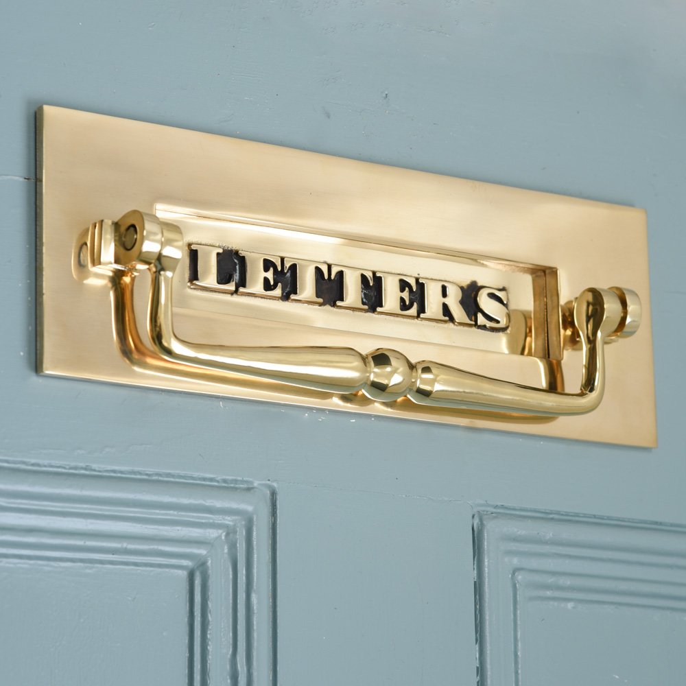 Classic brass letters letterplate with clapper on blue door