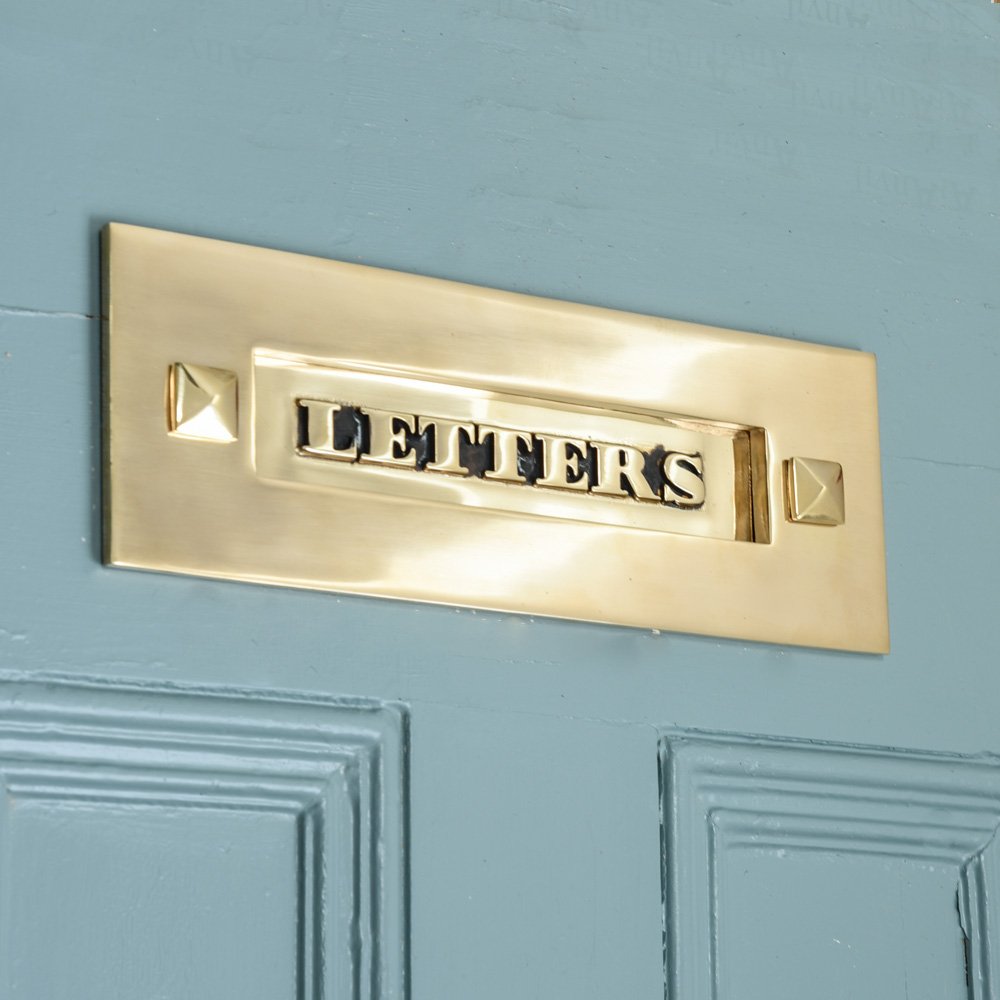 Classic brass letters letterplate on blue door