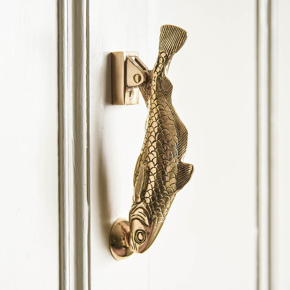 Brass Cod fish door knocker on cream painted front door