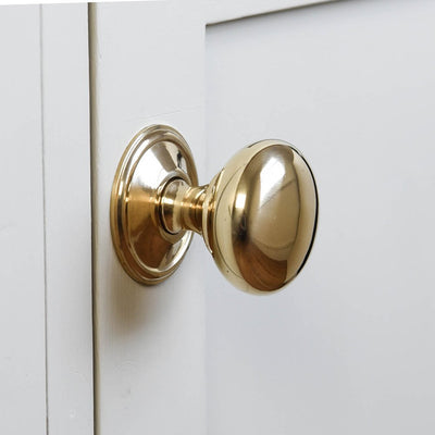 Cottage bun cabinet knob in polished brass close up