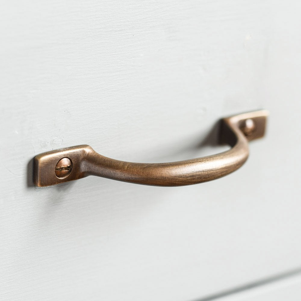D' Shaped Pull Handle in Distressed Antique Brass on white drawer