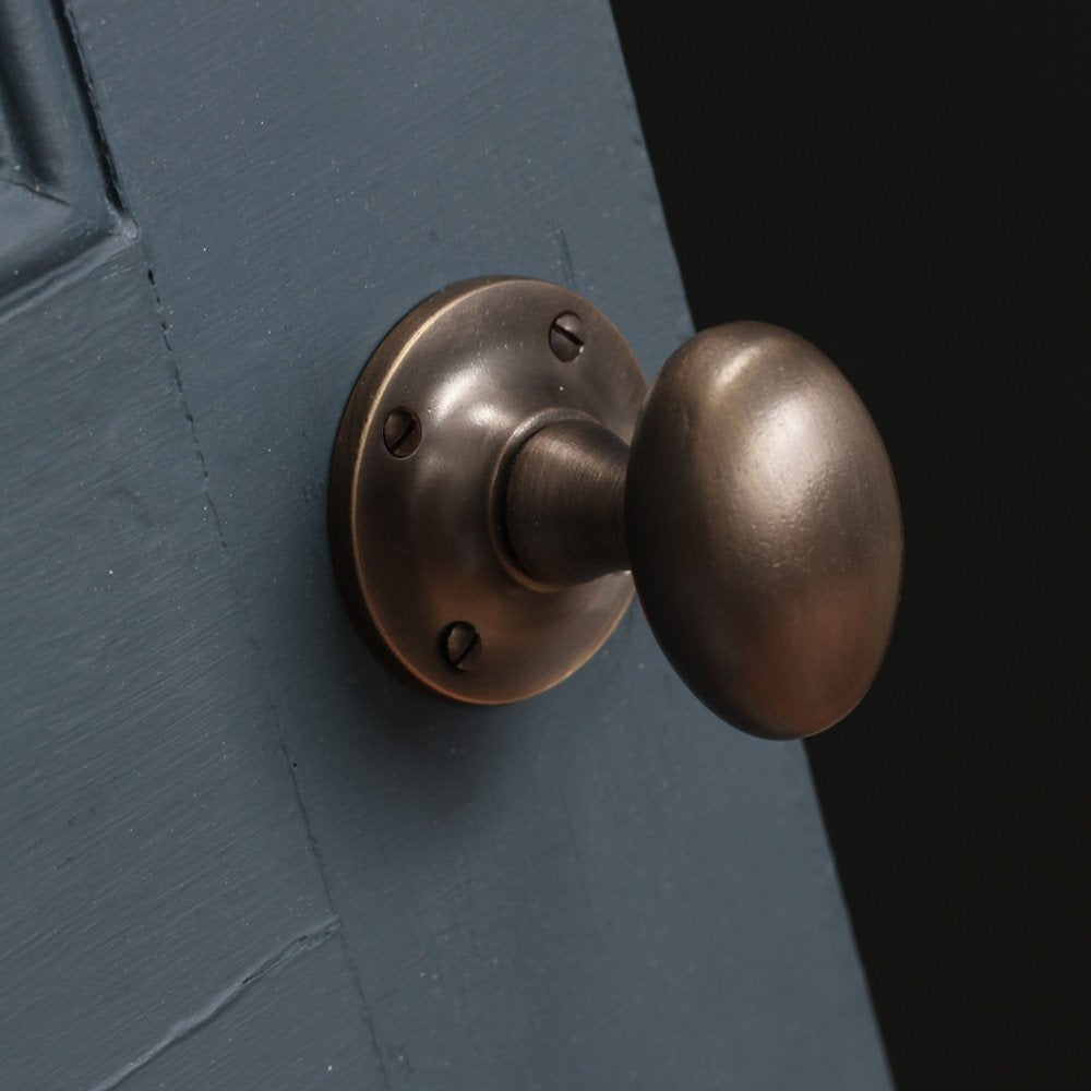 angled picture of oval door knob on door