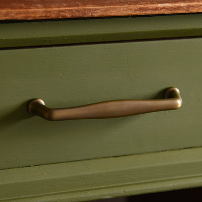 Distressed Antique Brass Elegance Pull Handle on green drawrs