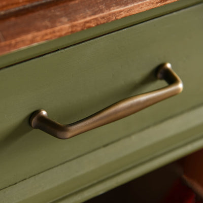 Distressed Antique Brass Elegance Pull Handle on green drawer seen on an angle