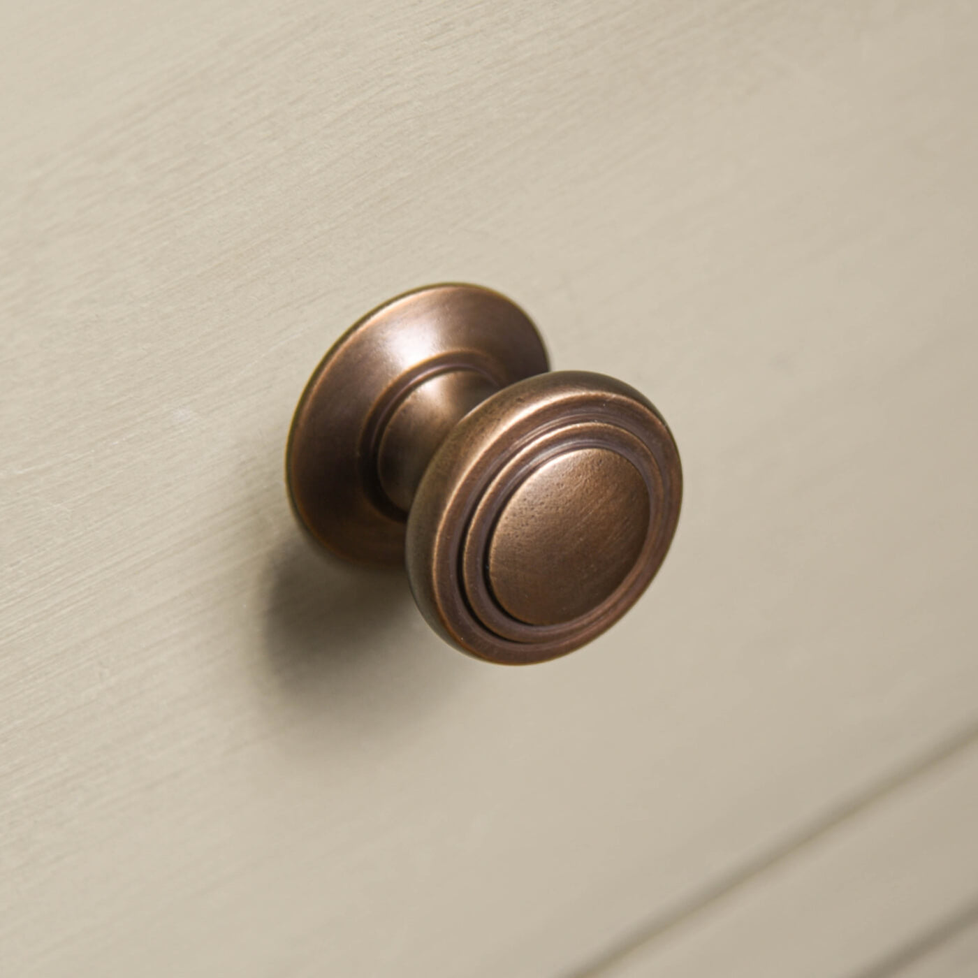 stepped cushion cabinet knob in distressed antique brass