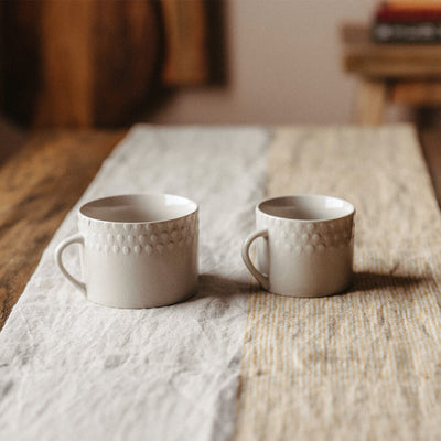 Ela Mugs on table seen in two sizes