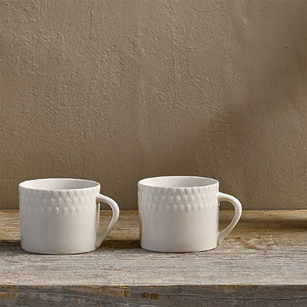 Pair of small embossed Ela mugs